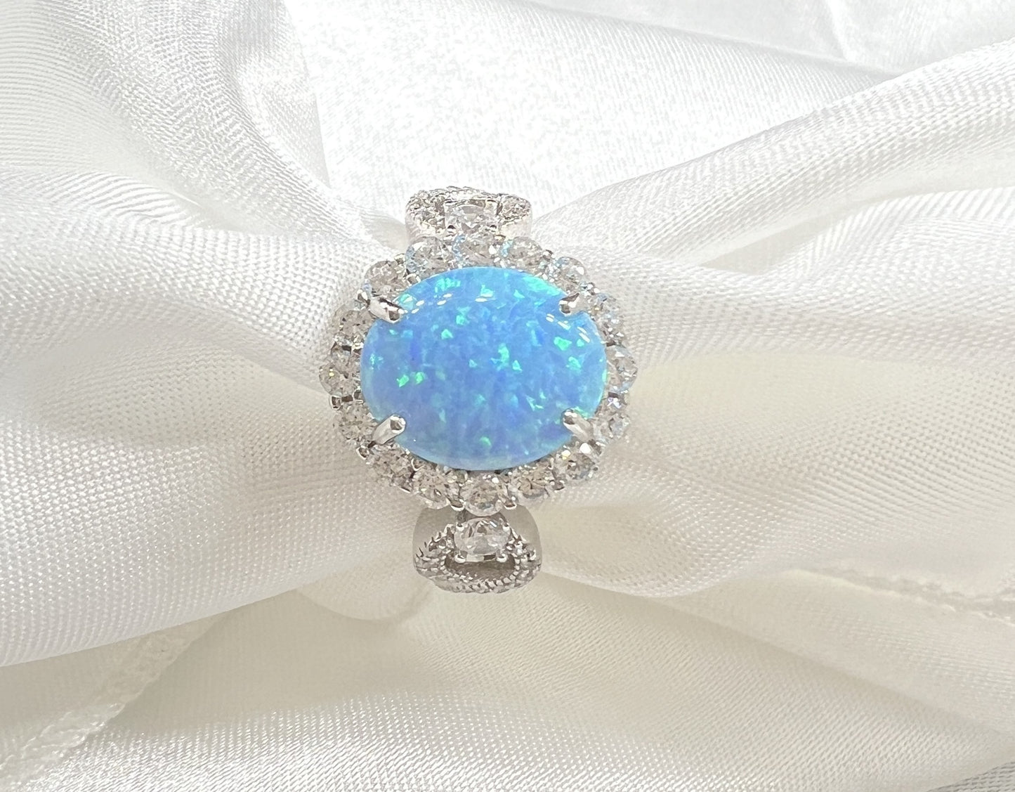 925 Sterling Silver Infinity Oval Cut Lab-Grown Blue Fire Opal & Diamond CZ